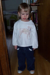 little girl with very crabby expression and stuck-out bottom lip