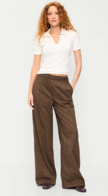 loose high-waisted brown plaid trousers that look comfy but elegant, and a snug-fitting cream polo shirt with a cute keyhole neckline